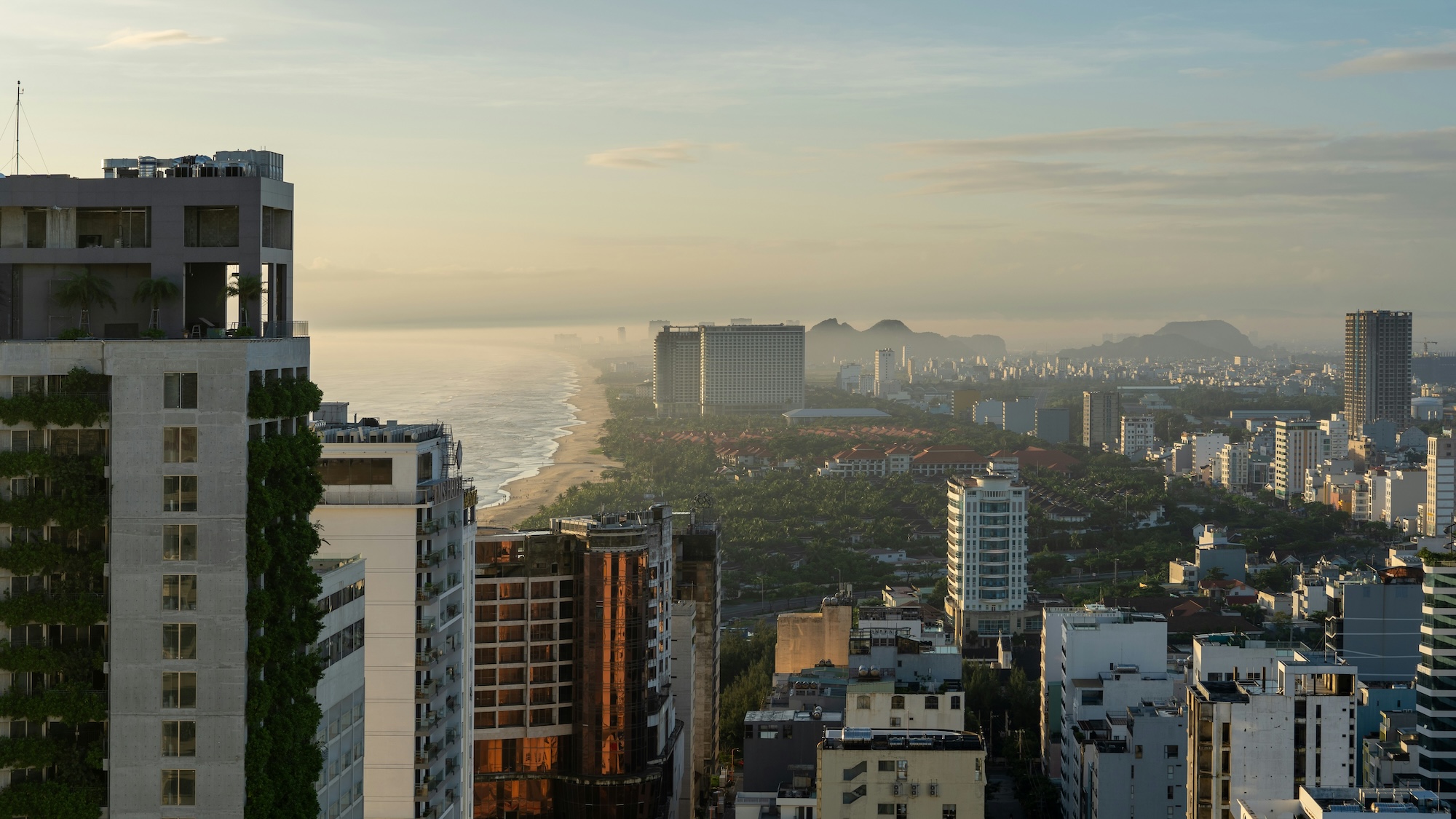 Danang Beach with boats and city's skyline